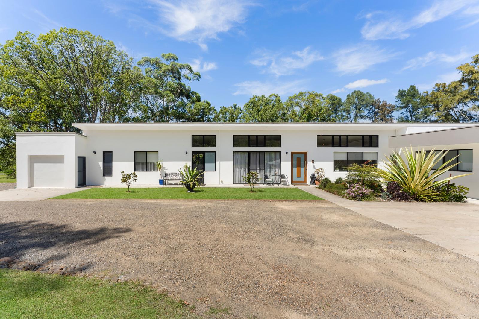 Long single storey rendered home renovation with large windows